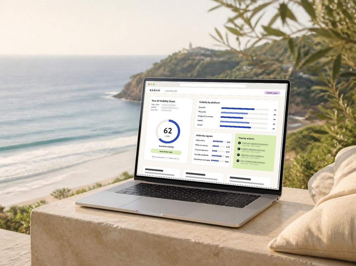 Laptop on a coastal terrace showing a sample Radar AI Visibility Score report